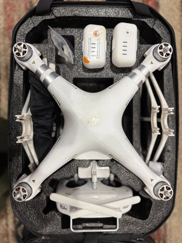 White quadcopter drone with accessories in protective case