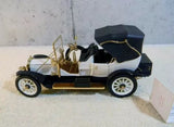 Franklin Mint 1912 Packard Victoria diecast model car, black with cream accents and gold trim