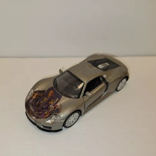 Gray diecast model sports car with detailed body and clear windows, front three-quarter view.