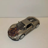 Gray diecast model sports car with detailed body and clear windows, front three-quarter view.