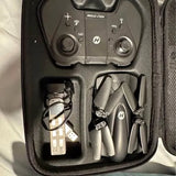 Holy Stone drone kit in case: controller, USB charging cable, and spare propellers