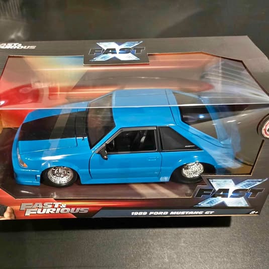 Blue diecast model car, 1980 Ford Mustang GT, Fast X packaging