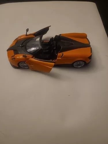 Orange and black roadster diecast model car, 1/24 scale