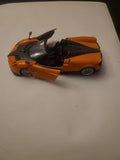 Orange and black roadster diecast model car, 1/24 scale