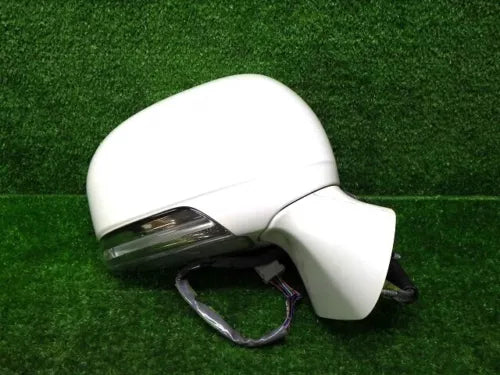 Light-colored diecast car model front side with headlight and side mirror