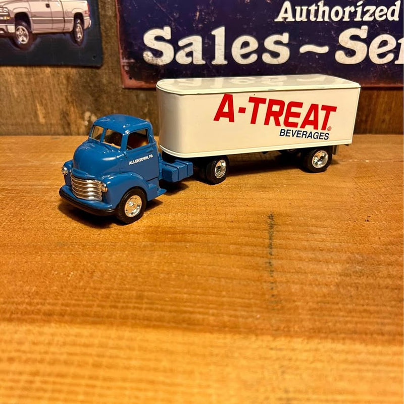 Blue diecast truck with A-TREAT beverages trailer, front view, detailed grille