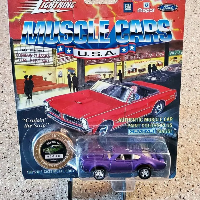 Red die-cast muscle car toy in retail box with window view