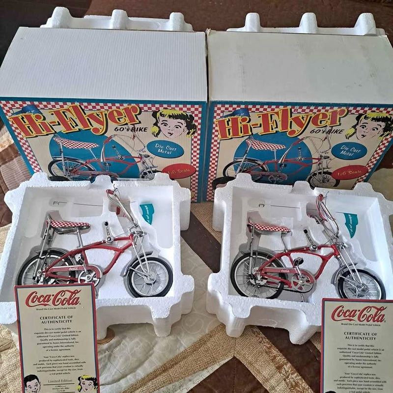 Diecast bicycle model in retail box, red-and-white bike with blue accents, Coca-Cola label