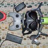 FPV drone with controller and batteries, black and gray
