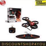 LED stunt drone with orange accents, spinning propellers, and charging controller pad