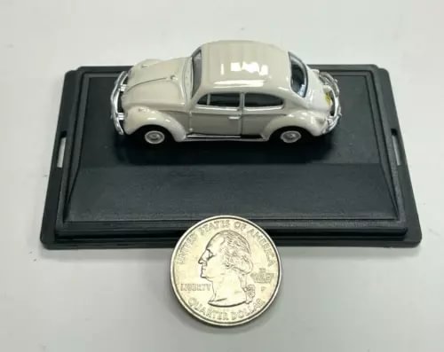 1:76 scale diecast Volkswagen Beetle model, off-white body with black base
