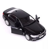 Black 1:36 diecast model car with open door and front lights, BMW M550i styling