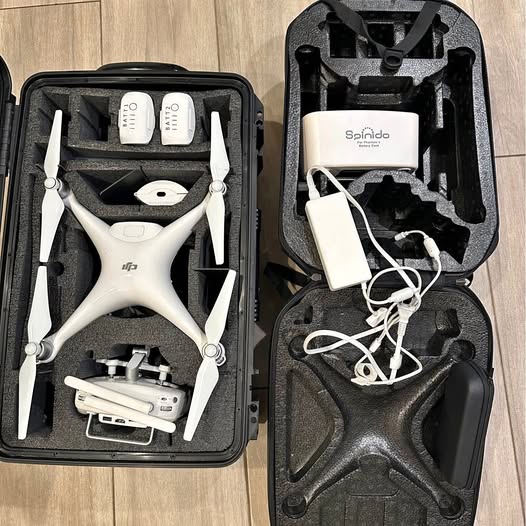 DJI Phantom 4 Pro drone in hard case with propellers, batteries, and charger