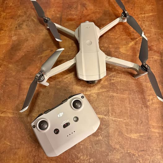DJI Mavic Air 2 drone with white propeller arms and white remote controller