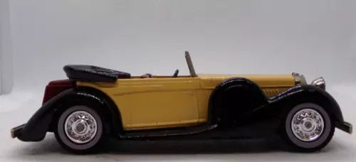 Yellow diecast coupe model car with black fenders, side profile, detailed wheels