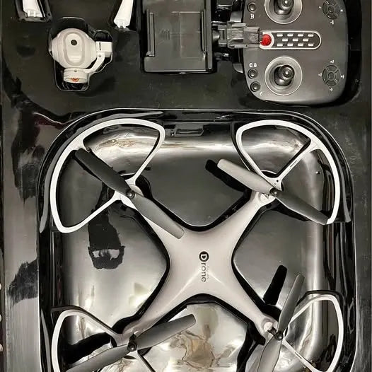 Silver and black quadcopter drone with four propellers in top view