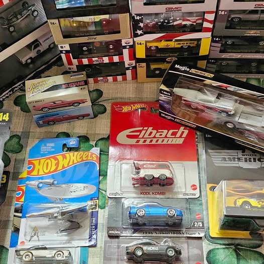 Diecast car models in blister packaging and retail boxes, assorted colors