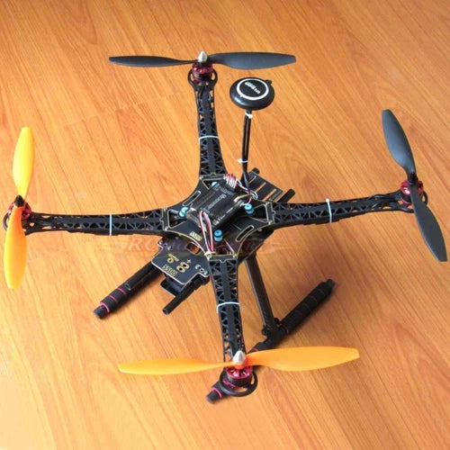 Quadcopter drone kit with black frame and four propellers, showing controller and GPS module