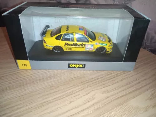 Yellow diecast model car in clear display box with ONYX logo on base