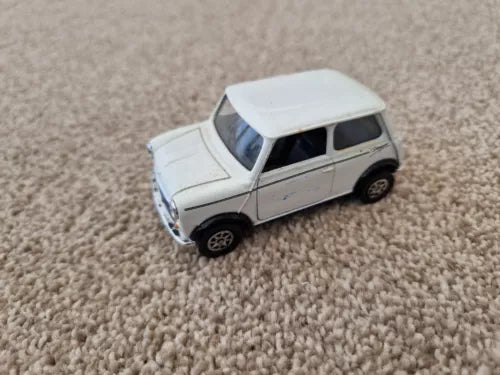 White 1:36 diecast mini cooper model car, front three-quarter view