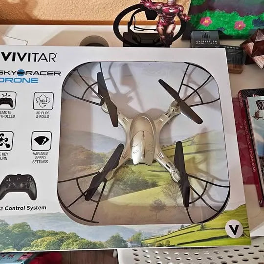 Vivitar SkyRacer drone in retail box with four-blade propellers illustration