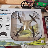 Vivitar SkyRacer drone in retail box with four-blade propellers illustration