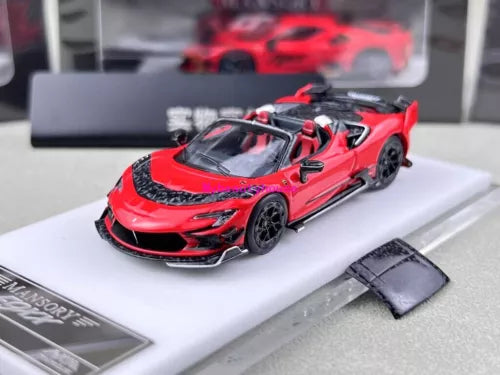 Red and black die-cast sports convertible model car on display base, front view