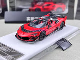 Red and black die-cast sports convertible model car on display base, front view