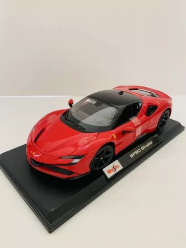 Red 1:18 diecast model car with black base and display nameplate, front 3/4 view