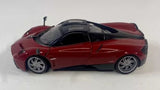 Dark red diecast model car, side profile with detailed wheels and molded body lines