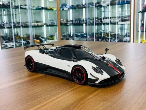 White and black carbon-fiber diecast sports car model with red wheel accents