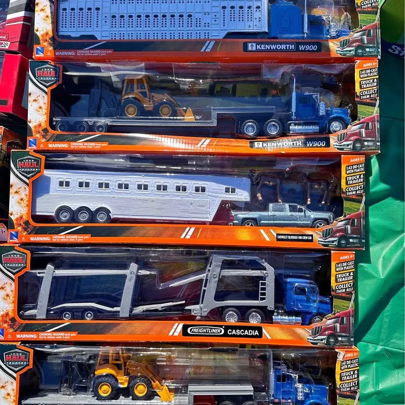1:43 scale diecast Kenworth W900 trucks and trailers in orange retail boxes