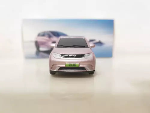 Pink 1/64 scale diecast car model, front view with headlights and grille.