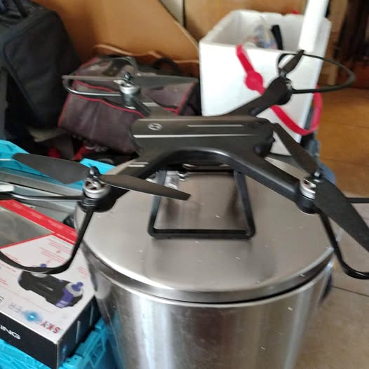 Quadcopter drone with four propellers and front camera mount