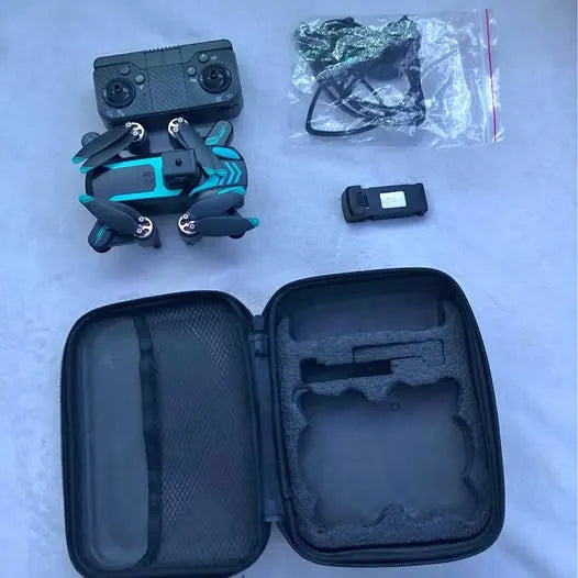 Quadcopter drone with teal body, remote controller, and open black carrying case