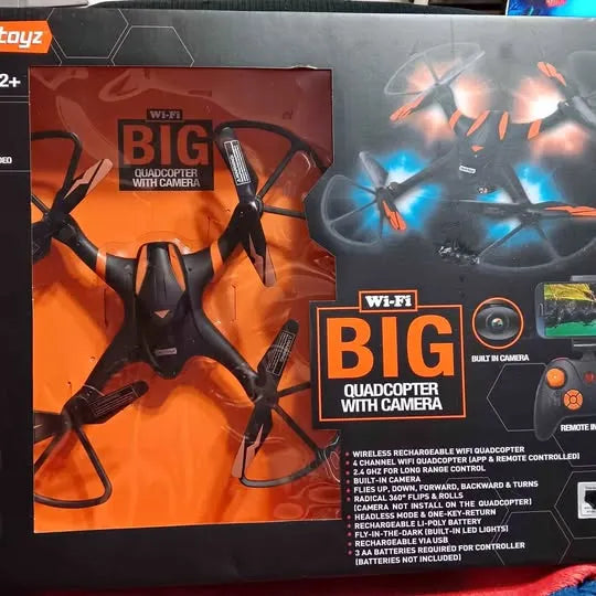 Wi-Fi quadcopter drone with camera on retail box, orange and black packaging