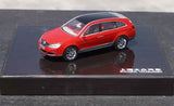Red alloy diecast car model, side view with black wheels and silver grille