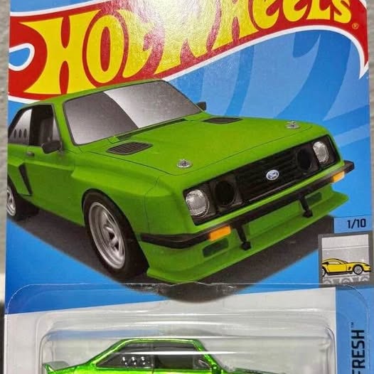 Green Hot Wheels diecast car in clear blister, front three-quarter view