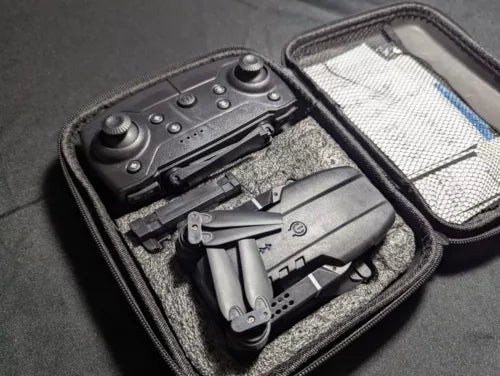 Folded drone and controller in hard-shell carrying case with phone-style display