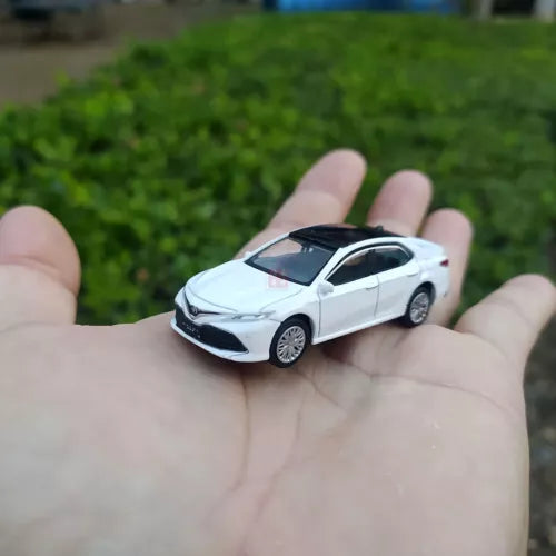 White diecast model car with black grille and silver wheels