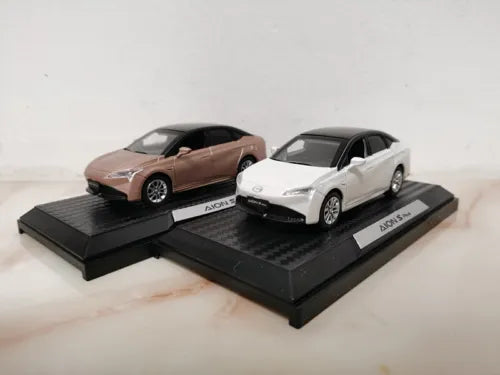 Diecast model car set with brown and white cars on display bases