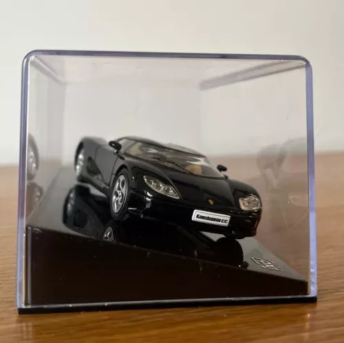 Koenigsegg CC8S diecast model car, black, front view with display case