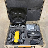 DJI Spark drone case with yellow drone body, remote, battery, and accessories
