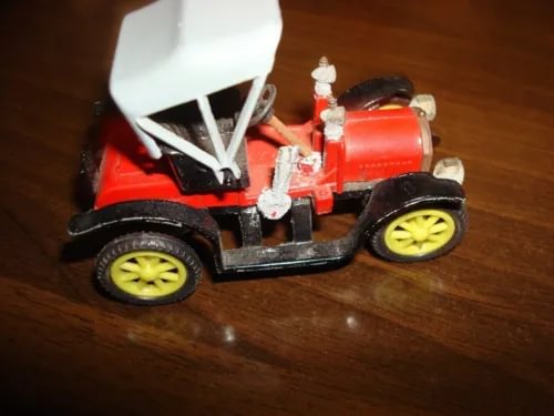 Vintage Opel Doktor die-cast model car, red body, open top, yellow wheels