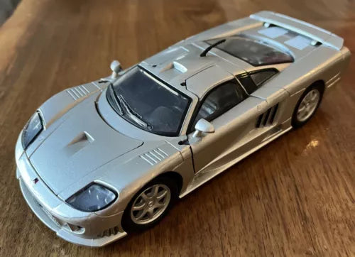 Silver diecast sports car model with black hood and side vents