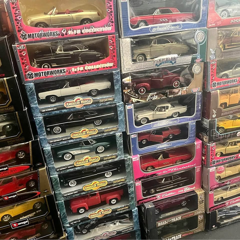 Set of boxed 1/18 vintage diecast cars with assorted colors and branding