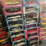Set of boxed 1/18 vintage diecast cars with assorted colors and branding