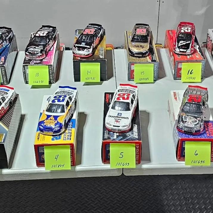 Diecast stock car display with multiple race cars in numbered boxes