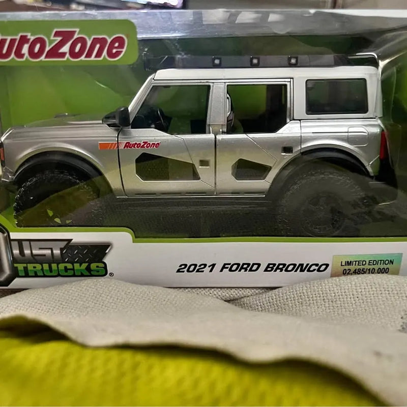 AutoZone diecast 2021 Ford Bronco model truck, silver body with green graphics