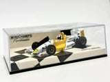 1:43 race car diecast model, yellow and white, in clear display case